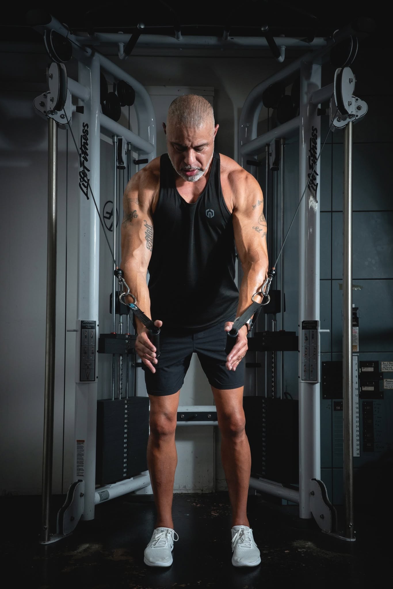 Ricardo performing a tricep pushdown on the cable machine